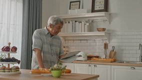attractive asian senior couple standing at white cozy kitchen, drinking fresh morning coffee together, enjoying good morning - Powered by Shutterstock - Get 15% off with code: PIKWIZARD15