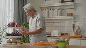 attractive asian senior couple standing at white cozy kitchen, drinking fresh morning coffee together, enjoying good morning - Powered by Shutterstock - Get 15% off with code: PIKWIZARD15