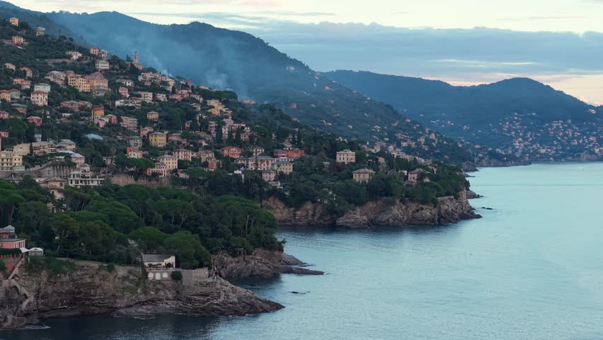 Charming Italian coastal town with colorful houses and boats nestled against a lush hillside