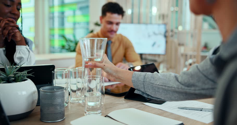Hands, business and person pour water for staff meeting with documents, hydration and discussion of project. People, glass and liquid beverage of conference, paperwork and proposal feedback in office