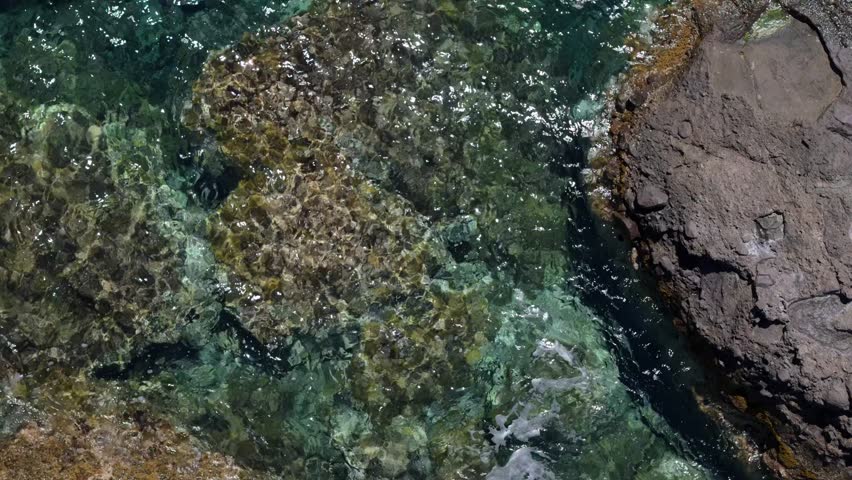 Closeup of a rock formation on the Sardinian coast. drone shot of italian beach.