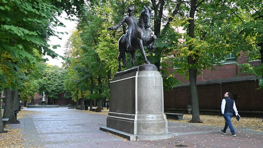 Boston, MA, USA - October 20, 2024: the historic architecture of Boston showcasing the iconic Paul Revere Riding a Horse statue at Hanover street across the memorable Old North Church. 