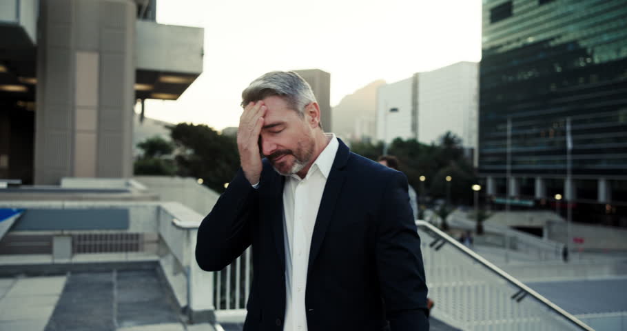 Mature, businessman and walking with stress in city for fatigue, mistake or anxiety for jobless day in debt. Tired man, unemployed or laid off with headache, depression or company bankruptcy in town