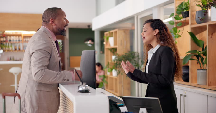 Man, concierge and problem with argument, mistake and drama in hotel lobby. Frustrated, customer and manager with dispute, angry and fight with schedule issue or booking crisis and upset with service