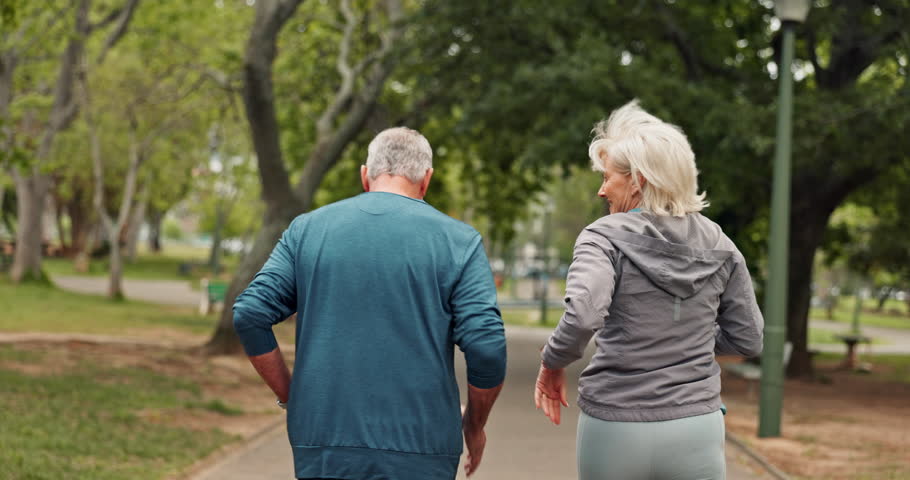 Running, park and back of senior couple for exercise, training and cardio workout together. Retirement, marriage and mature man and woman do fitness outdoors for wellness, healthy and mobility