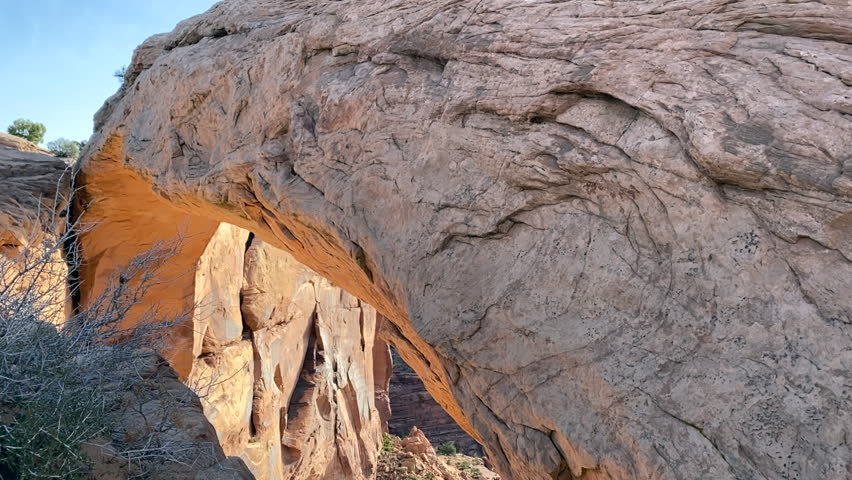 At the viewpoint over Canyonlands National Park, Utah, with the famous Mesa Arch in the foreground at sunrise. 