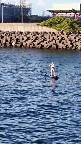 Young people enjoying marine sports such as SUP in Keelung City, Taiwan. September 2024