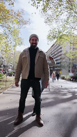 Vertical Portrait of beautiful multiracial happy couple outdoor young woman and man in love hugging and smiling in piggyback. Background street in christmas time. People dressed in winter clothes