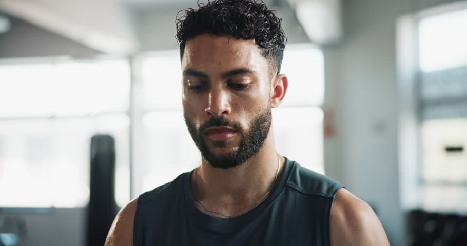 Gym, tired and face of man for fitness, physical workout and exhausted with sweat for training session. Serious, male person and bodybuilder in portrait with fatigue, recovery rest and exercise break