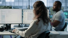 Employee sitting next to african american coworkers in data center doing checkup on electronics to avoid downtime. Engineer and colleagues supervising server room infrastructure components, camera A - Powered by Shutterstock - Get 15% off with code: PIKWIZARD15