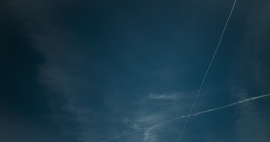 Fever-dream vision, runaway contrails and cirrus clouds, portray a blue sky in turmoil.