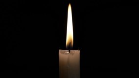 A hand strikes a match to ignite a candle in a darkened room, creating a warm glow. The flame flickers softly, illuminating the surrounding space. - Powered by Shutterstock - Get 15% off with code: PIKWIZARD15