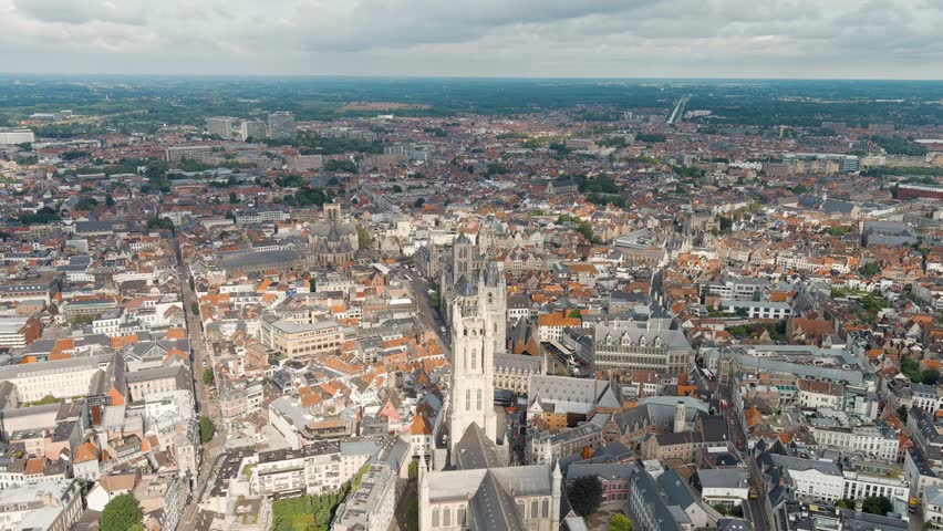 Dolly zoom. Ghent, Belgium. Cathedral of Saint Bavo. Panorama of the central city from the air. Cloudy weather, summer day, Aerial View, Departure of the camera
