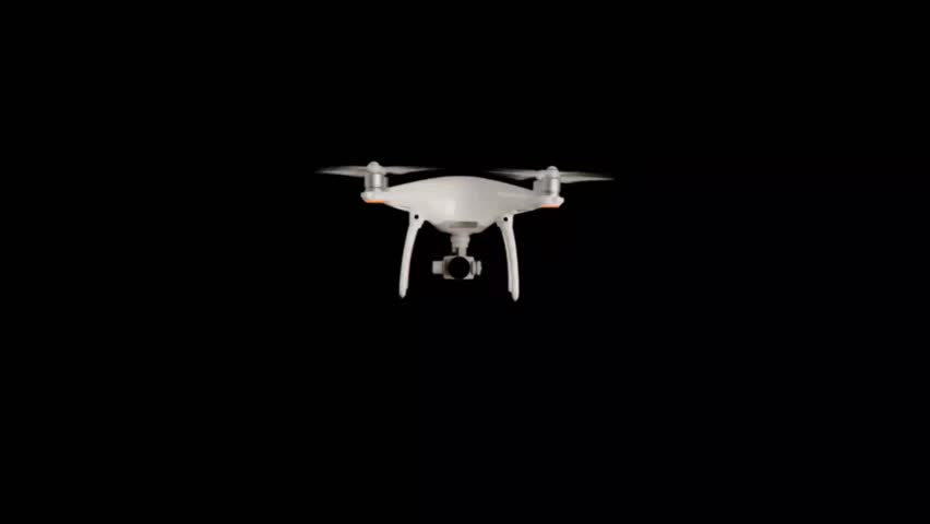 White drone hovering in dark background aerial view concept