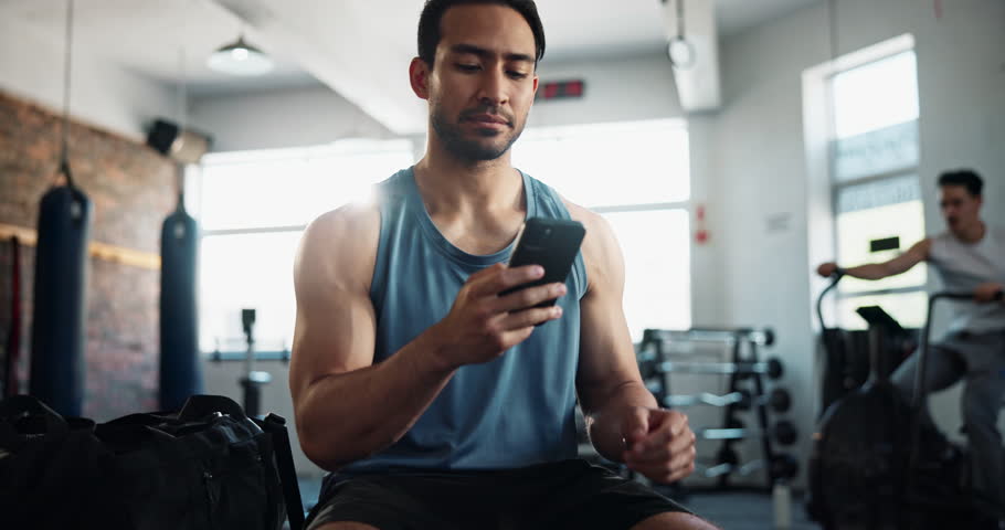 Man, gym and happy with smartphone for fitness on social media, networking and communication. Male person, body builder and laugh or smile on internet for funny videos, memes and entertainment