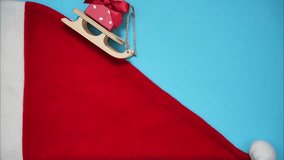 A wooden sleigh goes down Santa's hat. Stop motion animation - Powered by Shutterstock - Get 15% off with code: PIKWIZARD15