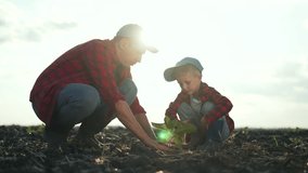 Father and son agriculture. Family teamwork as father teaches son plant crops. Agriculture bonding through father son teamwork. Family values in agriculture. Father guiding son family farming teamwork - Powered by Shutterstock - Get 15% off with code: PIKWIZARD15