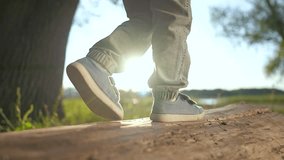 Child walking log in forest. kid balancing on tree trunk during forest walk. Outdoor adventure for child walking on log. Playful child exploring nature forest. Child's forest adventure walking on log. - Powered by Shutterstock - Get 15% off with code: PIKWIZARD15