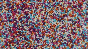 Sweet sugar sprinkles in rotation. colorful sugar balls,  Turning. colorful sugar pearls. sugar confetti, background - Powered by Shutterstock - Get 15% off with code: PIKWIZARD15
