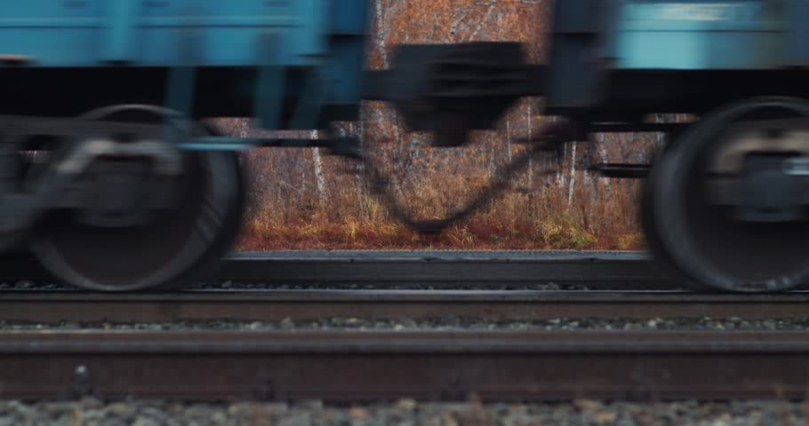 Cargo train wheels. Close-up of tracks and wheels of a freight train. Heavy long-haul trucking industry. Delivery of cargo and goods all over the world.