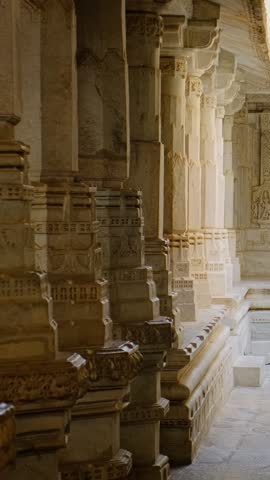 Inside the sacred Ranakpur Jain temple or Chaturmukha Dharana Vihara. Marble ancient medieval carved sculpture carvings of sacred religious place of jainism worship. Ranakpur, Rajasthan. India