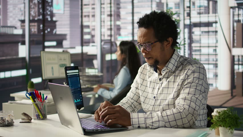 General manager sits at his laptop frustrated by the overload of business tasks. CEO dealing with fatigue and mental exhaustion after experiencing pressure in the office environment. Camera B.