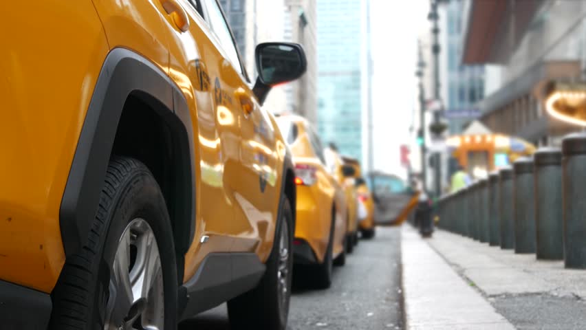 New York City Grand Central Terminal railway station, 42 street. Manhattan Midtown. Yellow taxi cab row, car transport on Pershing Square, NYC, USA. American urban road traffic, people pedestrians.