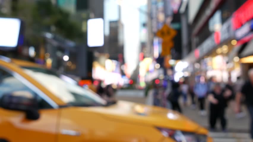 New York City Times Square, Manhattan Midtown Broadway street, USA. American NYC yellow taxi cab, urban road traffic. People. Advertising signs, commercial ads, illuminated billboard screens glowing.