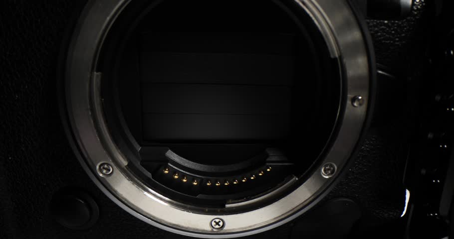 Closeup of camera lenses on white surface. Rotating photo lens rings to control aperture for camera