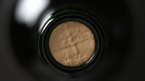 Close up of wine cork inside glass bottle, not opened bottle of wine, top view, rotates - Powered by Shutterstock - Get 15% off with code: PIKWIZARD15