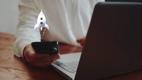 A businessman working on a laptop and with a smartphone demonstrates a hologram with a rocket flying upward. Concept of space achievements and growth. Cg - Powered by Shutterstock - Get 15% off with code: PIKWIZARD15