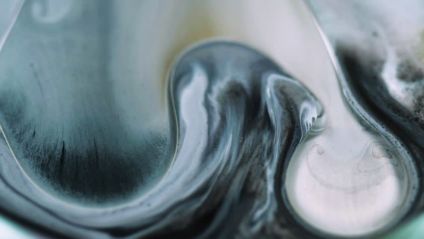 Oil fluid drop. Bubble paint spill. Defocused blue black white color particles texture ink emulsion flow motion abstract art background.