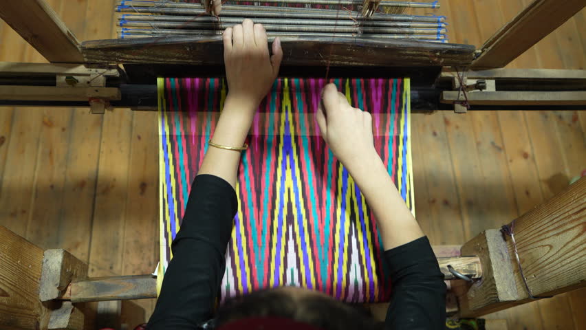 Weaving silk using traditional methods on a traditional loom