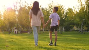 silhouette family child mother go in green park. mother son teenager holding hands. happy child communication with mother. concept support motivation - Powered by Shutterstock - Get 15% off with code: PIKWIZARD15