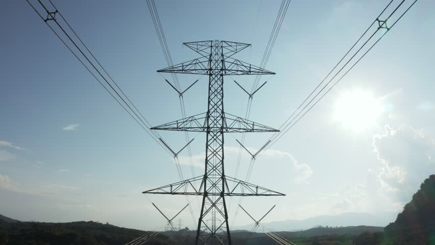 Transmission tower in aerial view. May called electricity pylon, steel utility pole consist of steel structure framing to support carry high-voltage cable or overhead power line for electrical grid.