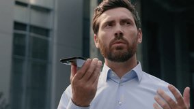 Smartphone talking microphone loudspeaker dictate to mic translation Caucasian businessman employer middle-aged man record audio message voice mail business male adult guy in city talk mobile phone - Powered by Shutterstock - Get 15% off with code: PIKWIZARD15