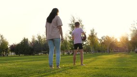 mother catch up kid   playing rugby. summer family play ball teamwork.  family park - Powered by Shutterstock - Get 15% off with code: PIKWIZARD15