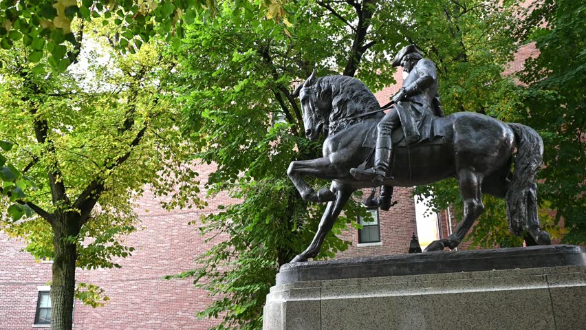 Boston, MA, USA - October 17, 2024: the iconic architecture of Boston showcasing the famous Paul Revere Riding a Horse statue at Hanover street across the Old North Church on a sunny day.