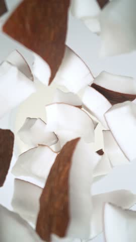 Super Slow Motion of Falling Coconut Pieces into Cream. Filmed on High Speed Cinema Camera, 1000fps, Placed on High Speed Cine Bot. Camera in Motion, Following Objects, Vertical