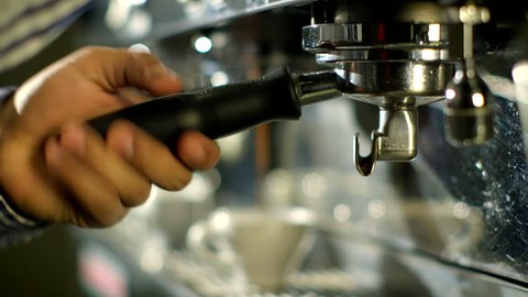Barista makes two coffees in coffee bar     
