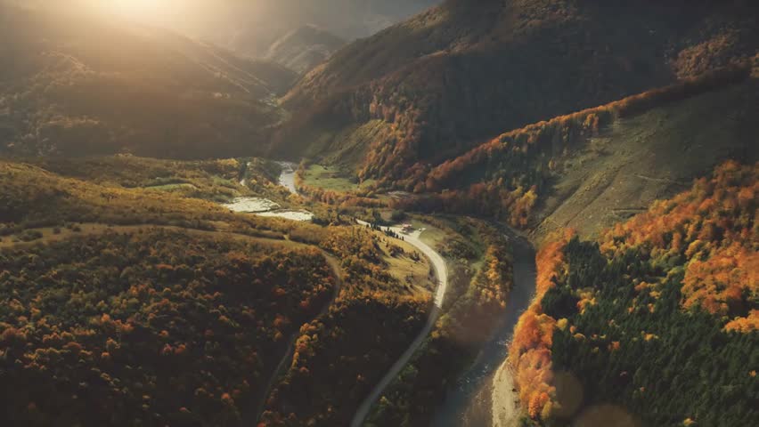 Aerial View Drone Flight Over Fantastic Canyon Mountain River Dramatic Autumn Nature Landscape Green Meadows Orange Hills Pine Tree Forests Against Sunset Sky Carpathians Ukraine Europe 4k 00:29