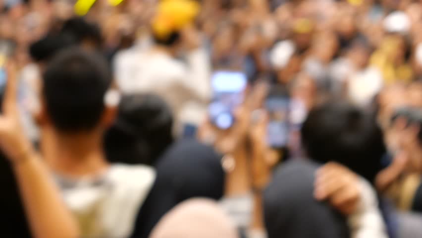 Crowded fans using mobile phones to take photos of celebrity