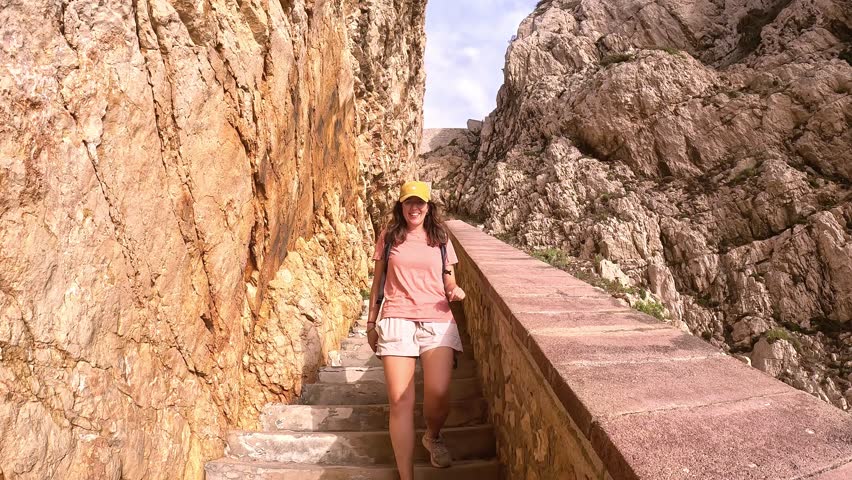 Girl Walks on Coastal Stairway in Sardinia, POV Reveal Seaside Pathway