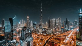 Timelapse view of iconic skyscrapers and traffic on major interchange at night in Downtown Dubai, United Arab Emirates (UAE). Modern cities and skylines, business and finance concept. - Powered by Shutterstock - Get 15% off with code: PIKWIZARD15