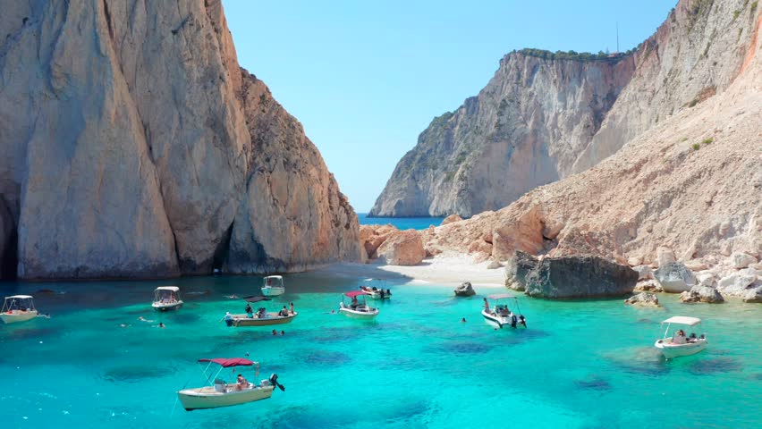 Motorboat Rentals Charter a Motor Yacht and explore Greece. Small pleasure fun boats on beach in Greek island of Zakynthos. Akra Keri Zante. Mizithres Rock