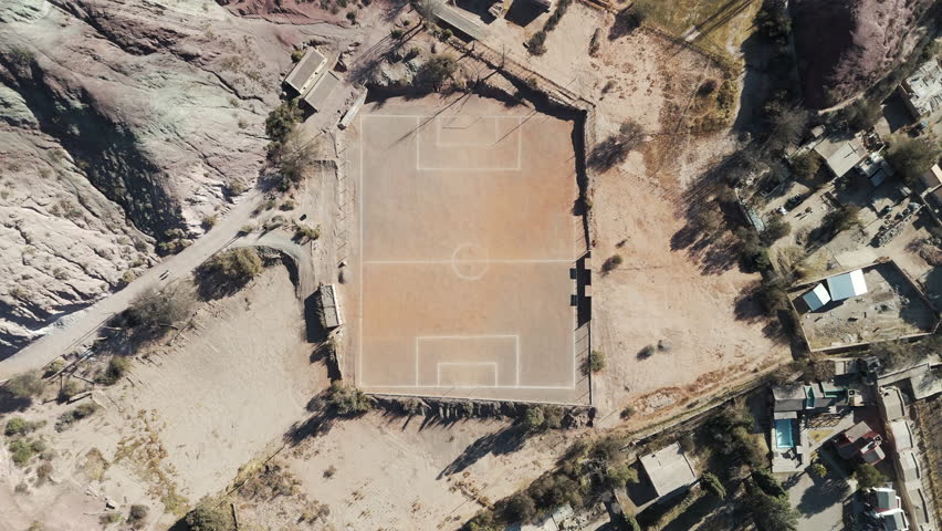 Small football field in the heart of Purmamarca, Jujuy desert, viewed from above by a drone.