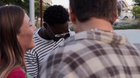 Diverse Group of College or High School Students Share Cheerful Moments Between Classes, Carrying Folders and Backpacks While Leaning. Teenage Classmates talking and having a friendly conversation - Powered by Shutterstock - Get 15% off with code: PIKWIZARD15