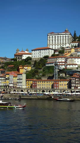 Porto City, Douro River on Sunny Day. Episcopal Palace and Historical Center. Portugal. Boat is Passing By. Vertical Video