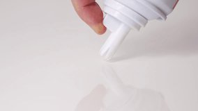 Whipped milk cream from the tube is squeezed onto a white surface. A delicious milk dessert. - Powered by Shutterstock - Get 15% off with code: PIKWIZARD15