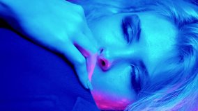 Vertical video. Romantic party. Neon light couple. Holiday bonding. Caring loving woman embracing boyfriend in blue red pink color glow on shiny tinsel. - Powered by Shutterstock - Get 15% off with code: PIKWIZARD15